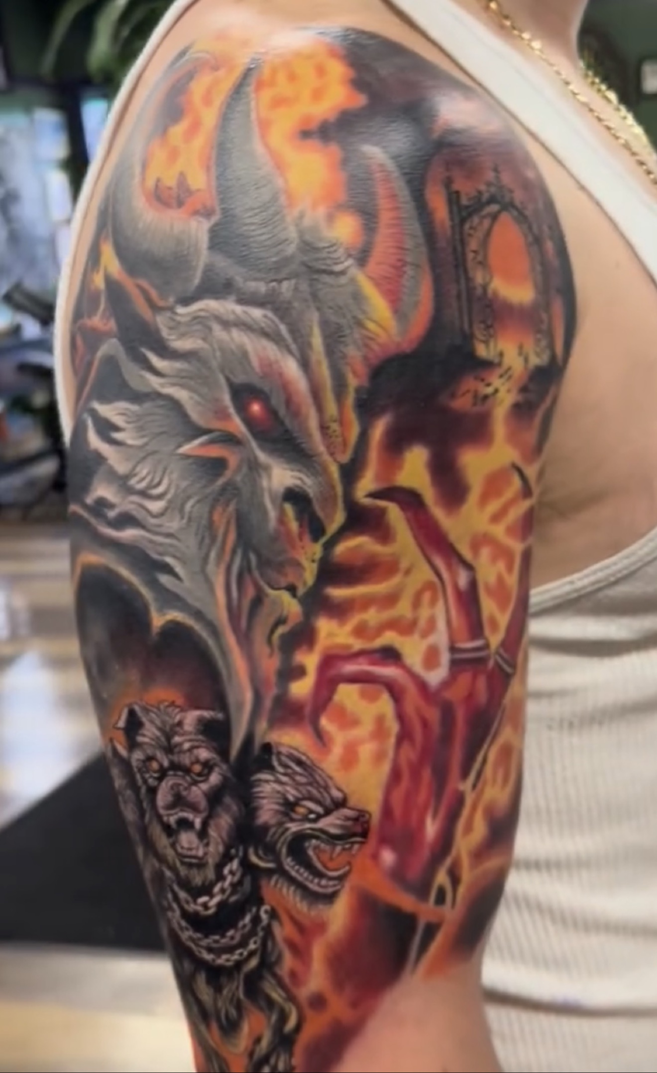 Full-color dark realism tattoo of a demonic hellhound surrounded by flames
