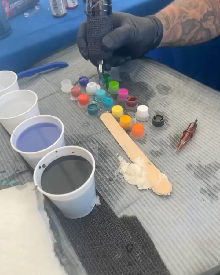 Tattoo machine and ink caps at the work station