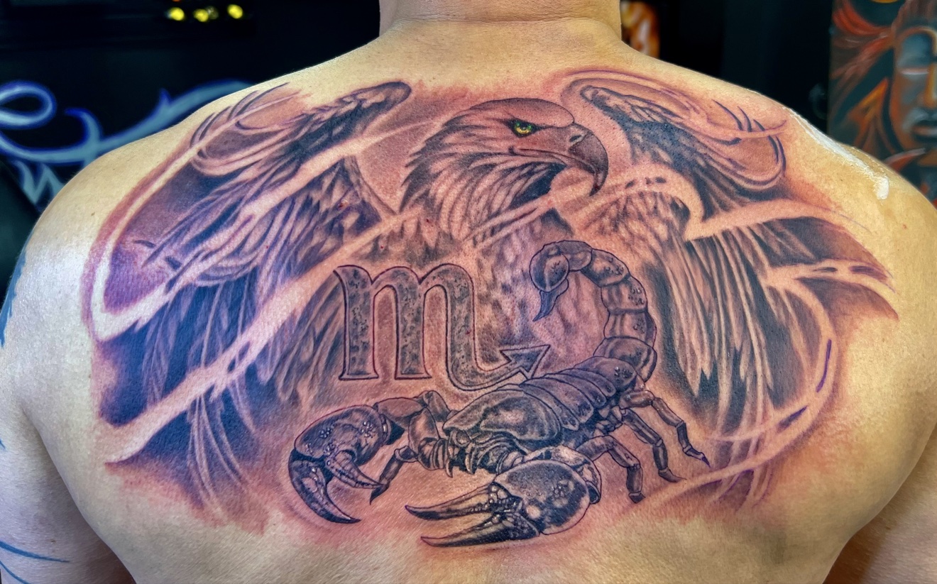 Black and grey eagle and scorpion back piece tattoo